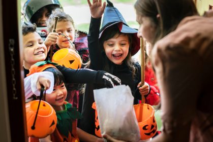 Little,Children,Trick,Or,Treating,On,Halloween