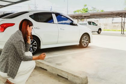 Young,Woman,Holding,A,Car,Key,Sits,Dumbfounded,At,Her