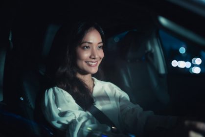 Woman driving at night